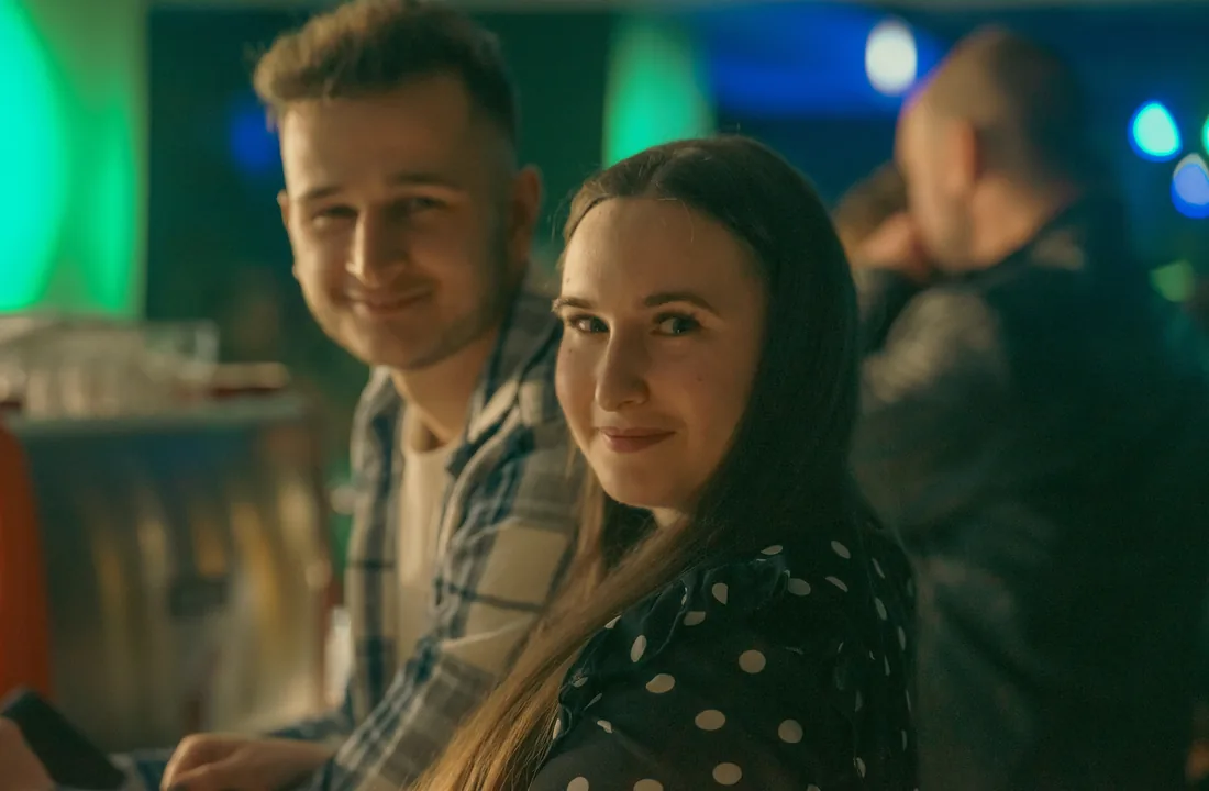Pár a pultnál a 1444-ben, meleg fényekkel — esti bár hangulat.
